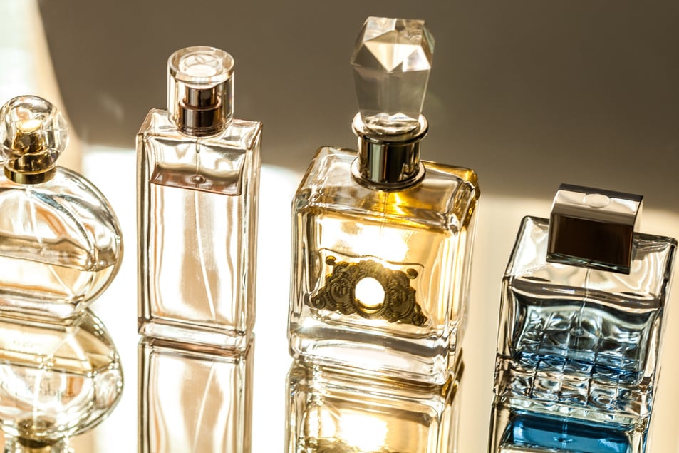 Aromatic Perfume Bottles on Background